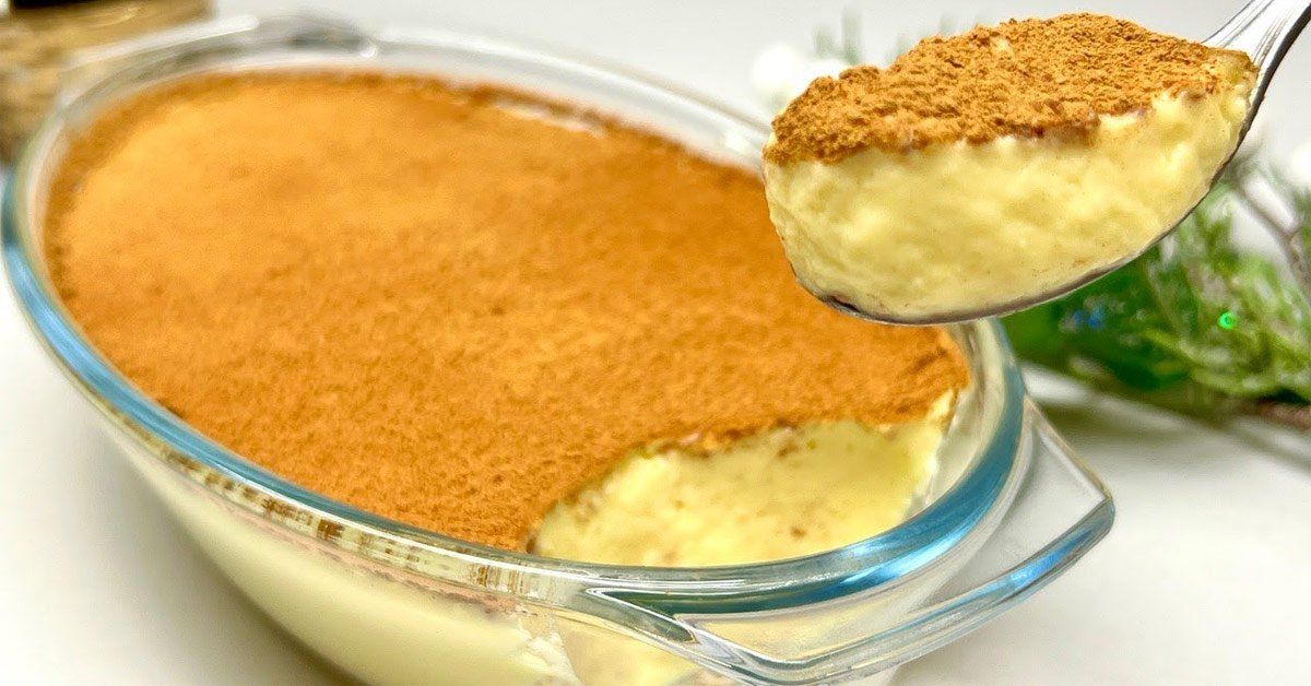 Chilled No-Bake Lemon Milk Pudding in a glass bowl, topped with a sprinkle of cinnamon and chocolate bits, ready to be enjoyed. The creamy texture and vibrant lemon zest decoration invite a taste of this quick and effortless dessert