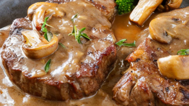 Image of a hearty dish of Slow Cooker Swiss Steak, showcasing tender beef steaks bathed in a rich mushroom sauce, beautifully presented in a rustic slow cooker. The image captures the essence of a home-cooked meal, ideal for cozy family gatherings, emphasizing keywords like 'slow cooker recipes,' 'comfort food,' and 'family dinner ideas' for optimal search engine visibility.