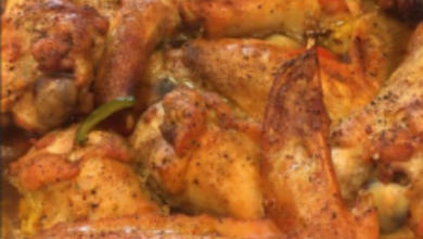 Crispy golden turkey wings fresh out of the oven served on a rustic ceramic platter, accompanied by mason jars filled with rich, homemade turkey stock, ready for holiday cooking