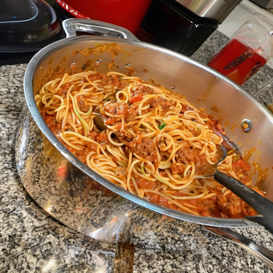 Delicious One-Pot Spaghetti Bolognese with ground beef, topped with grated Parmesan cheese, ready to be served