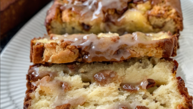 Delicious apple fritter bread with a golden-brown crust, topped with a cinnamon-sugar mixture and a sweet glaze, perfect for a fall dessert