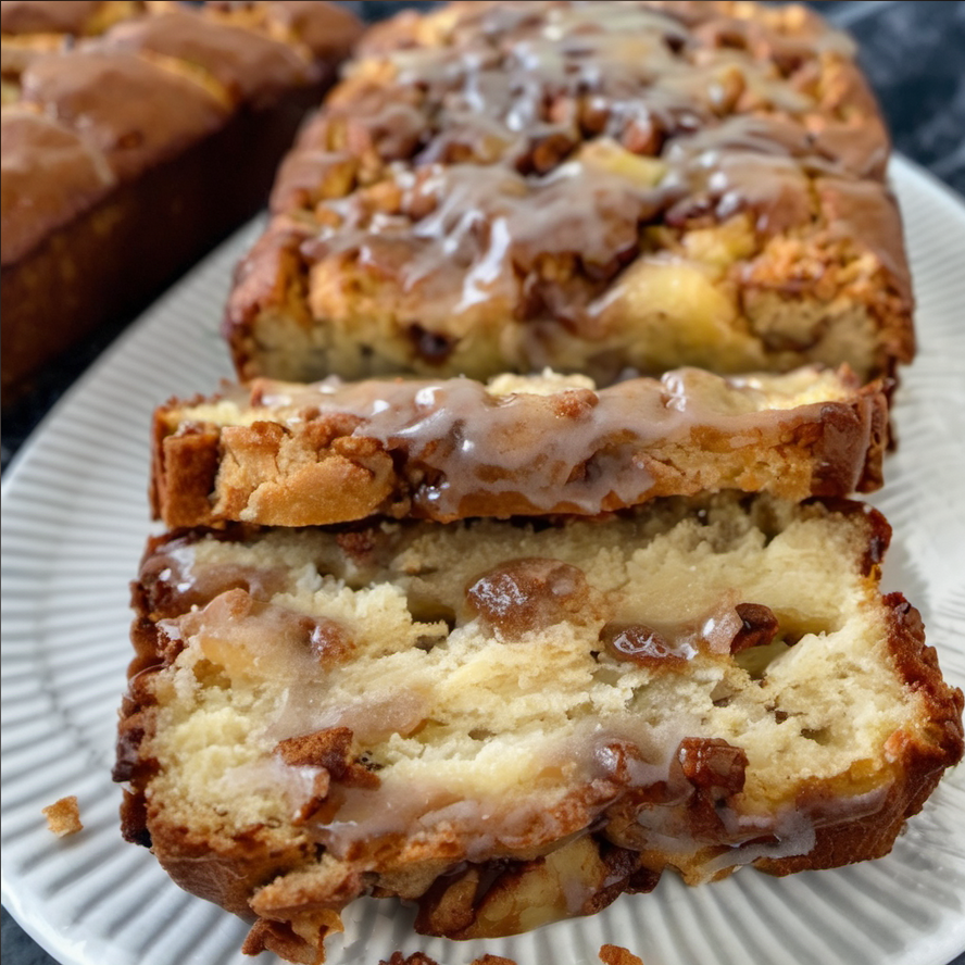 Delicious apple fritter bread with a golden-brown crust, topped with a cinnamon-sugar mixture and a sweet glaze, perfect for a fall dessert