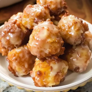 Apple fritter bites with apple cider glaze, served on a baking sheet