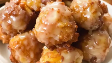 Apple fritter bites with apple cider glaze, served on a baking sheet