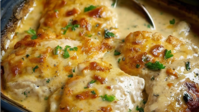 Tender chicken breasts coated in a creamy, cheesy sauce, sprinkled with Parmesan cheese, and baked to perfection