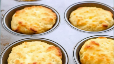 Delicious golden-brown Low Carb Biscuits freshly baked in a muffin tin, displayed on a cooling rack with a light, airy texture visible, perfect for a healthy, guilt-free treat