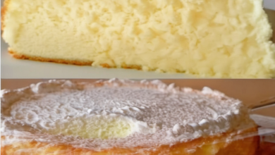 Freshly baked Fluffy Cloud Cake in a round pan, cooling on a wire rack, with a golden top and visible airy texture, perfect for a light and delicious dessert