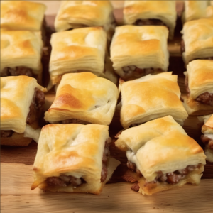 Golden-brown crescent rolls stuffed with savory sausage and melted cheese, served on a chic serving tray, ready to delight guests at any festive gathering