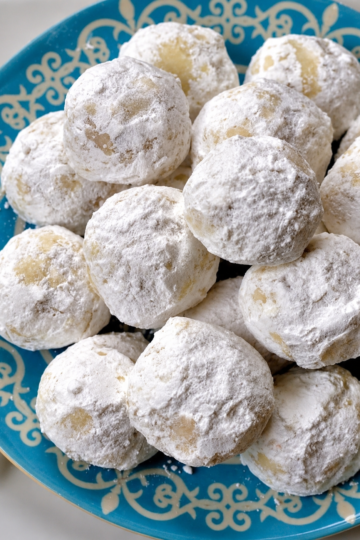 Delicious buttery pecan snowball cookies coated in powdered sugar, perfect for holiday treats
