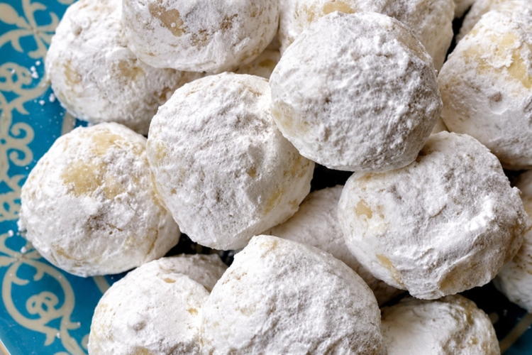 Delicious buttery pecan snowball cookies coated in powdered sugar, perfect for holiday treats