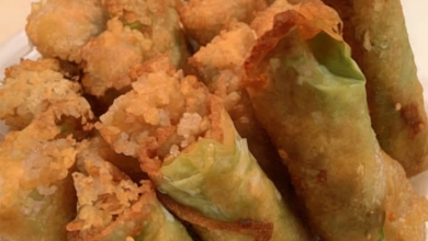 Delicious homemade egg rolls served on a plate with sesame seeds sprinkled on top, ready to enjoy with a dipping sauce