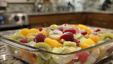 Delicious frozen fruit salad with a creamy base and colorful fruit pieces, served in a stylish dish