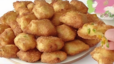 Crispy vegetable cheese beignets on a plate, served with a dipping sauce