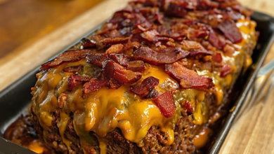 A beautifully baked bacon cheeseburger meatloaf, fresh out of the oven, with a golden-brown topping.