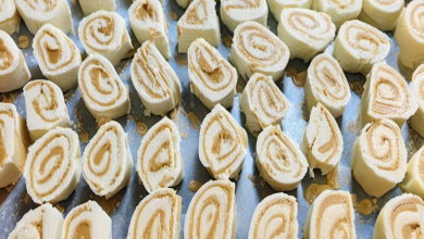 A delicious peanut butter roll sliced into pieces, showing the creamy peanut butter filling swirled inside the smooth, sugary dough.