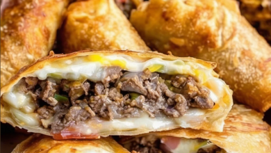 Preparing gourmet Philly cheesesteak filling for luxurious egg rolls, perfect for upscale game day catering