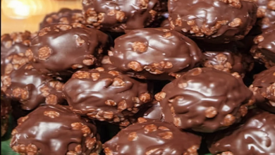 A plate of chocolate-coated Rice Krispie balls, topped with shredded coconut and chopped nuts, offering a nutritious and delicious snack option for health-conscious individuals