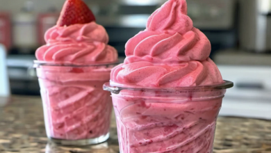 Blending frozen strawberries and pineapple juice for a refreshing homemade Strawberry Dole Whip