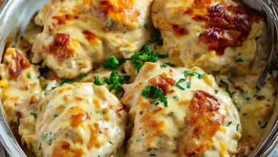 Juicy chicken breasts topped with a creamy cheese sauce, ready to bake