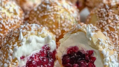 Crispy golden pastry balls filled with rich cream and fresh berries, ready to serve