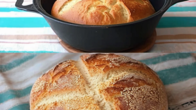 Freshly baked homemade bread loaf with a golden crust cooling on a wire rack