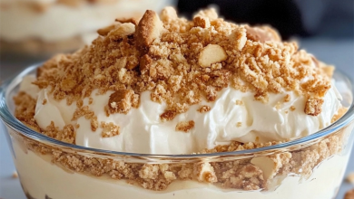 Easy no-bake dessert layered with whipped cream and crushed cookies in a glass dish