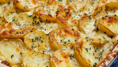 Creamy homemade scalloped potatoes with golden-brown top in a baking dish