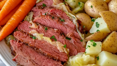 Slow cooker corned beef and cabbage served with potatoes and carrots on a white platter