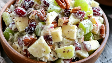 Refreshing apple salad with grapes, pecans, and dried cranberries in a creamy dressing