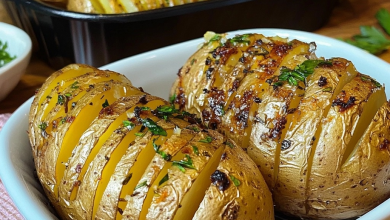 Baked potatoes golden and crispy on the outside, filled with garlic and herbs, served on a plate garnished with fresh parsley