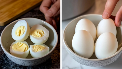 A perfectly peeled hard-boiled egg sitting on a plate, showing its smooth white surface