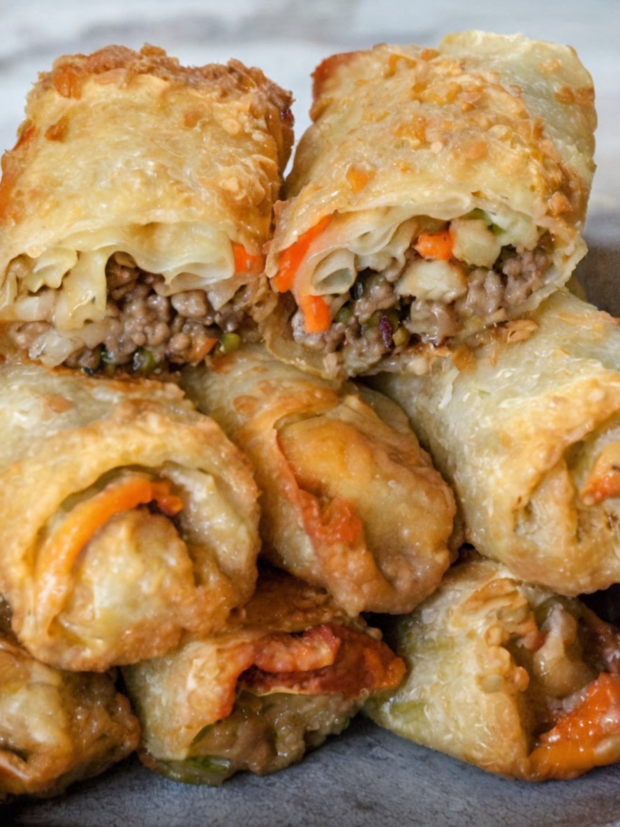 Crispy golden-brown Philly cheesesteak egg rolls filled with beef, onions, bell peppers, and melted cheese