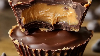 A beautifully crafted chocolate peanut butter cup cut open to reveal a rich, creamy center."