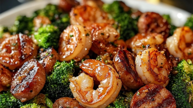 A mouthwatering plate of honey garlic shrimp, sausage, and broccoli served over rice, garnished with green onions