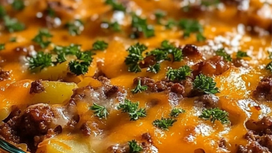 A golden-baked casserole with layers of cheesy potatoes and savory meatloaf, garnished with fresh parsley