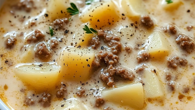 Close-up of creamy crockpot hamburger and potato soup with cheddar cheese and green onions on top