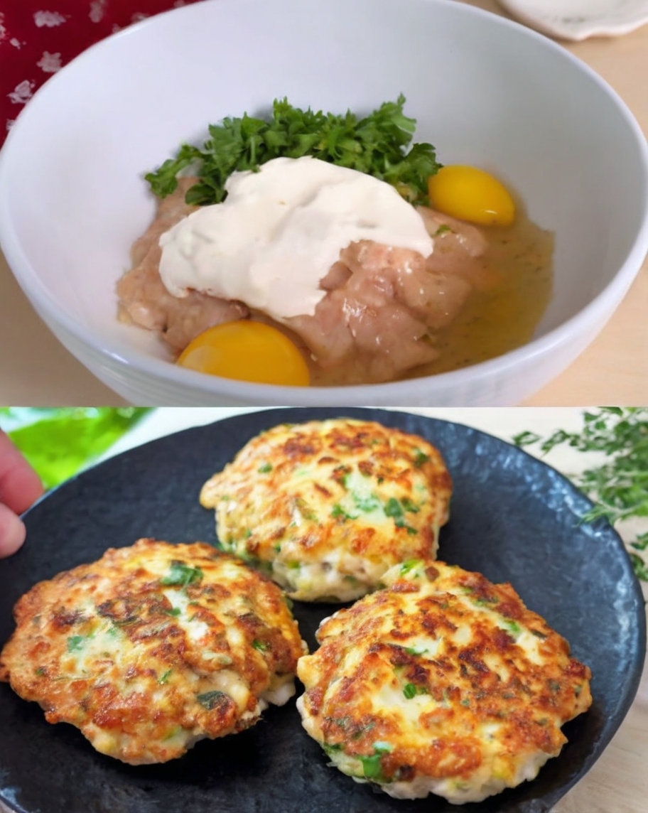 A vibrant close-up of golden-brown chicken burgers on a serving plate, garnished with fresh parsley and paired with a side of mixed greens, cherry tomatoes, and a lemon wedge for an added pop of color.
