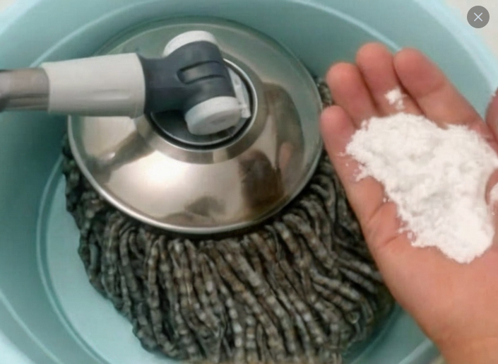 A clean, shiny wooden floor after using a homemade dust-resistant cleaning solution with household ingredients