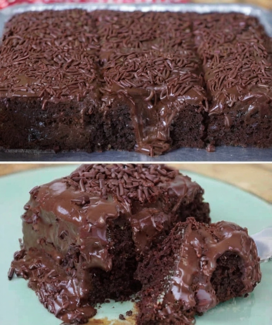 A rich and moist chocolate cake topped with glossy chocolate coating, garnished with grated dark chocolate, served in a rustic wooden tray with a side of fresh strawberries and a steaming cup of coffee.