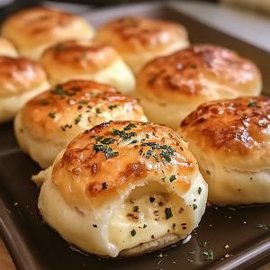 Buttery biscuit dough stuffed with gooey mozzarella cheese, brushed with garlic butter, and baked to golden perfection.