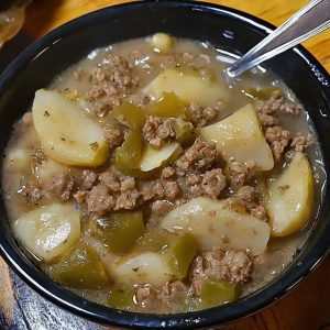 A savory Mexican dish featuring ground beef, roasted green chiles, potatoes, and spices.