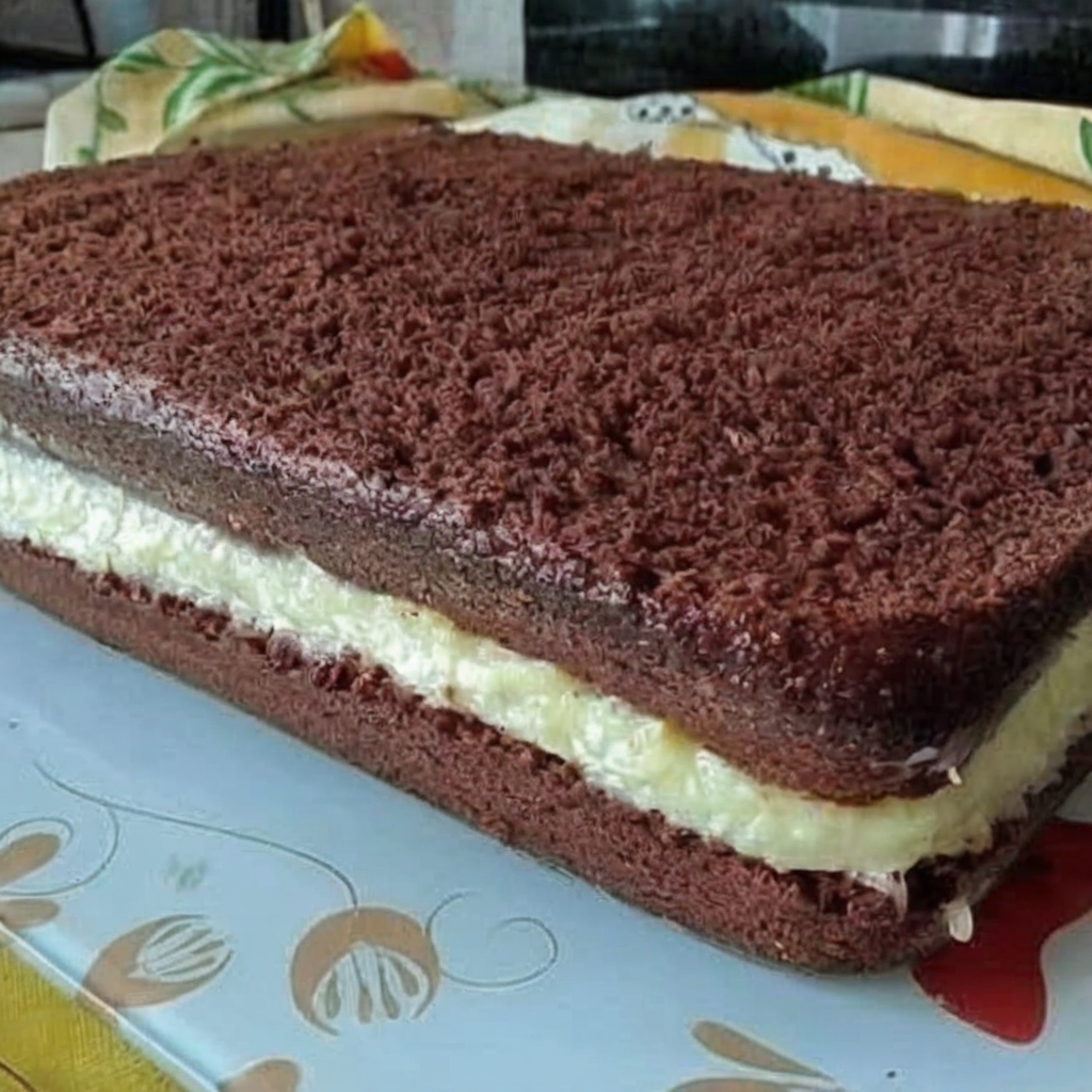 Chocolate sponge cake layered with creamy vanilla filling, perfect for desserts or special occasions