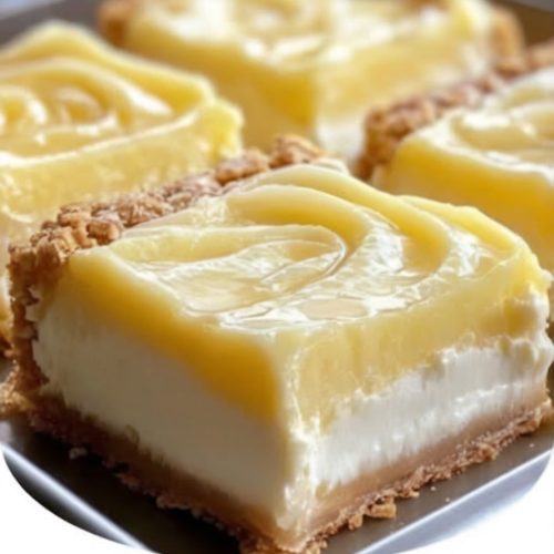 Tangy lemon cream cheese bars with a buttery shortbread crust and a dusting of powdered sugar.
