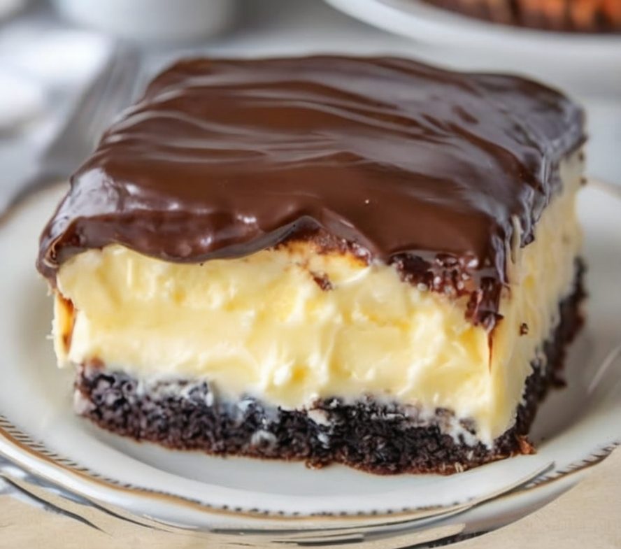 A moist yellow cake filled with vanilla pudding and topped with rich chocolate ganache. Easy, indulgent, and perfect for making ahead.