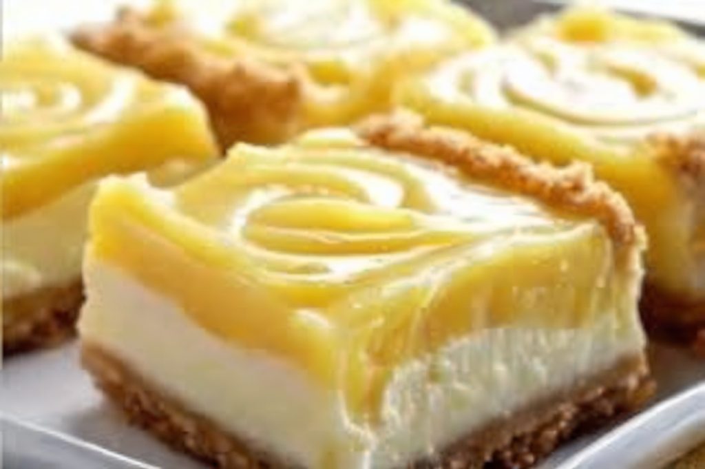 Tangy lemon cream cheese bars with a buttery shortbread crust and a dusting of powdered sugar.