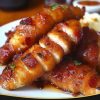 Juicy chicken tenders wrapped in crispy bacon and coated in a sweet brown sugar glaze. Quick, easy, and addictively delicious!