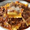 This easy Crockpot Ravioli Lasagna is a cheesy, hearty slow cooker meal that’s perfect for weeknights. Made with frozen ravioli, pasta sauce, and three kinds of cheese, it’s a family dinner winner