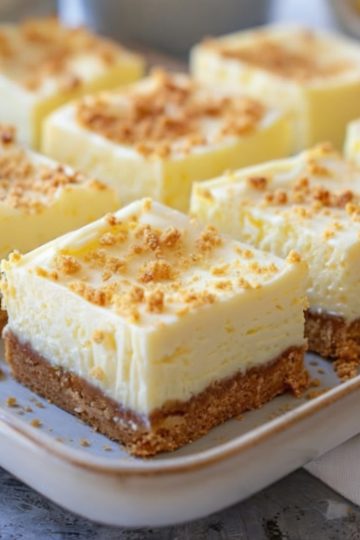 A tangy, creamy dessert bar made with a buttery graham cracker crust and a bright lemon cheesecake filling.