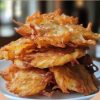 These classic onion fritters are golden, crispy, and packed with sweet onion flavor—perfect as a snack, side, or comfort food treat.