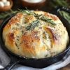 A crusty, flavorful artisan bread made with garlic and rosemary—no kneading required! Perfect for beginners and can be baked in the oven or air fryer.